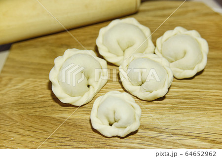 Five dumplings of round shape on the wooden deck. 64652962