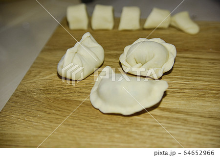 three dumplings of different shape on the wooden 64652966