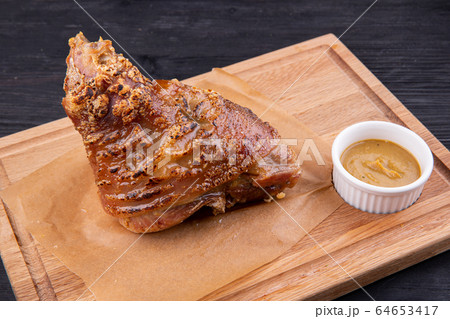 Rolls baked in an oven with spices are served with mustard Rolls baked in an oven with spices are served with mustard 64653417