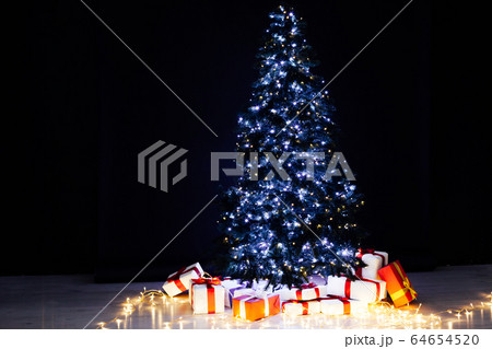 Christmas tree with gifts lights garlands New Year December Christmas tree with gifts lights garlands New Year December 64654520