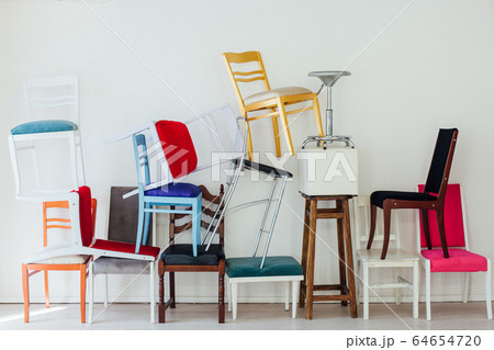 different multicolored chairs in the interior of the white room different multicolored chairs in the interior of the white room 64654720