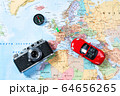 Model of red car, vintage camera and compass lie on Map of Europe 64656265