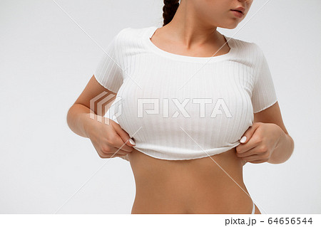 Crop sensual young lady taking off shirt 64656544