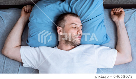 Man Sleeping And Snoring Lying In Bed In Bedroom, Top-View Man Sleeping And Snoring Lying In Bed In Bedroom, Top-View 64658075