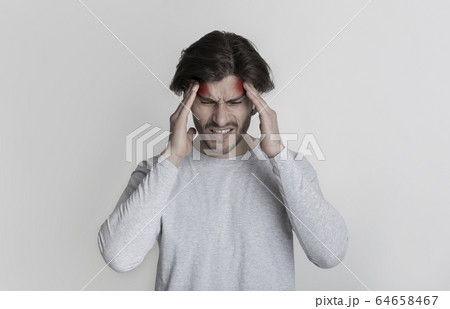 Man holds on to head, highlighted by red spots Man holds on to head, highlighted by red spots 64658467