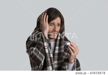 High fever during flu. Man with blanket 64658678