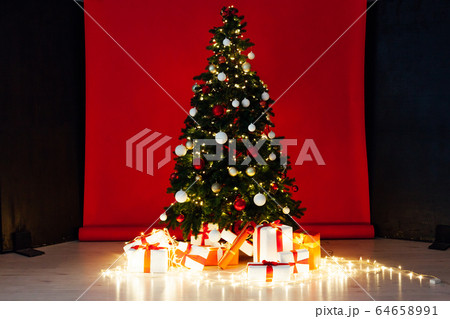 Christmas tree with gifts garland new year interier red room 64658991