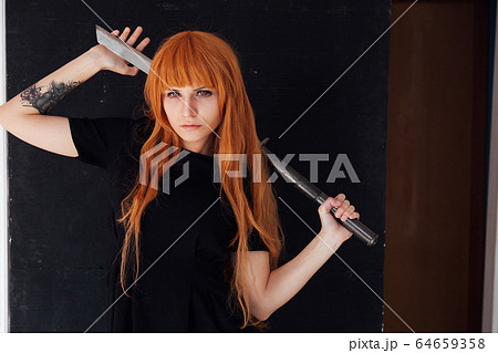 Portrait of a beautiful girl with a Japanese sword cosplayer anime Japan 64659358