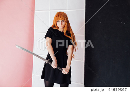 Portrait of a beautiful girl with a Japanese sword cosplayer anime Japan 64659367