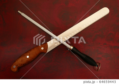 Knife and Sharpener On A Cutting Board 64659443