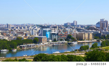 Paris, France - August 26, 2019: Paris from above showcasing the capital city's rooftops, the Eiffel Tower, Paris tree-lined avenues with their haussmannian buildings and Montparnasse tower. 16th 64660384
