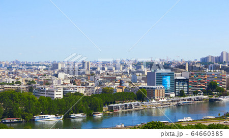 Paris, France - August 26, 2019: Paris from above showcasing the capital city's rooftops, the Eiffel Tower, Paris tree-lined avenues with their haussmannian buildings and Montparnasse tower. 16th 64660385