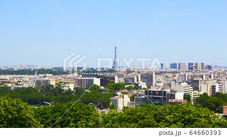 Paris, France - August 26, 2019: Paris from above showcasing the capital city's rooftops, the Eiffel Tower, Paris tree-lined avenues with their haussmannian buildings and Montparnasse tower. 16th 64660393