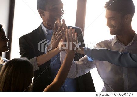 Happy diverse business team give high five motivated by success 64660477