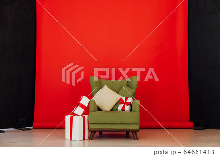 green vintage chair with gifts in the interior of the red room green vintage chair with gifts in the interior of the red room 64661413