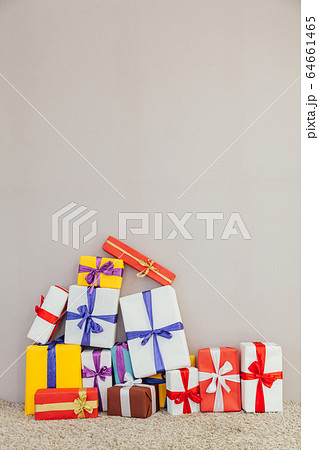 lots of multi-colored gifts on a gray background 64661465