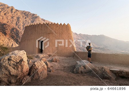 Traveler exploring Dhayah Fort in north Ras Al Traveler exploring Dhayah Fort in north Ras Al 64661896