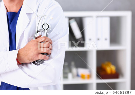 Male medicine doctor arms crossed on his chest in office Male medicine doctor arms crossed on his chest in office 64661897
