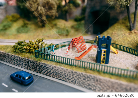 Miniature playground. Grandmother and grandson play in the playground 64662630