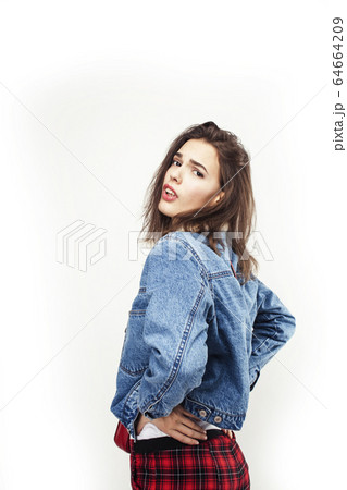 young pretty teenage hipster girl posing emotional happy smiling on white background, lifestyle people concept 64664209