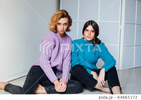 Portrait of two beautiful young fashionable female girlfriends together Portrait of two beautiful young fashionable female girlfriends together 64665172