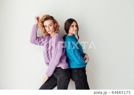 Portrait of two beautiful young fashionable female girlfriends together Portrait of two beautiful young fashionable female girlfriends together 64665175