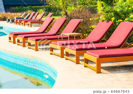 Beautiful empty chair around outdoor swimming pool in hotel resort 64667645