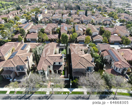 Aerial view suburban neighborhood with identical villas next to each other. San Diego, California 64668305