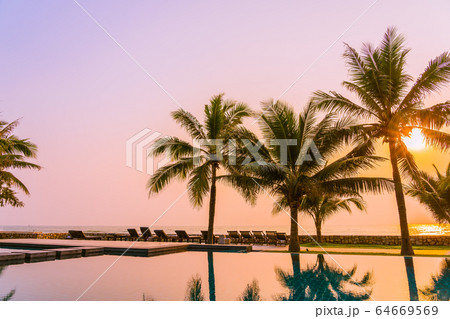 Beautiful nature with palm tree around outdoor swimming pool in hotel resort nearly sea ocean beach Beautiful nature with palm tree around outdoor swimming pool in hotel resort nearly sea ocean beach 64669569