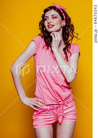 Portrait of a beautiful fashionable woman in pink pinap clothes Portrait of a beautiful fashionable woman in pink pinap clothes 64670343
