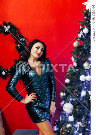 Beautiful brunette woman at Christmas tree new year holiday gifts Beautiful brunette woman at Christmas tree new year holiday gifts 64673044