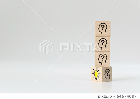 Wooden cube block flip over with head human symbol and light bulb icon Wooden cube block flip over with head human symbol and light bulb icon 64674087