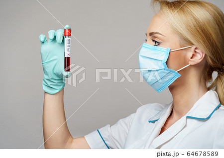 medical doctor nurse woman wearing protective mask and gloves - holding virus blood test 64678589