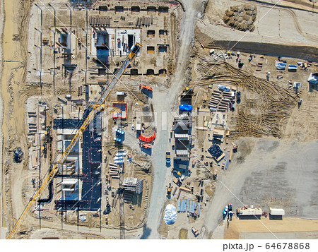 Aerial view of new construction site with crane and building materials.  64678868