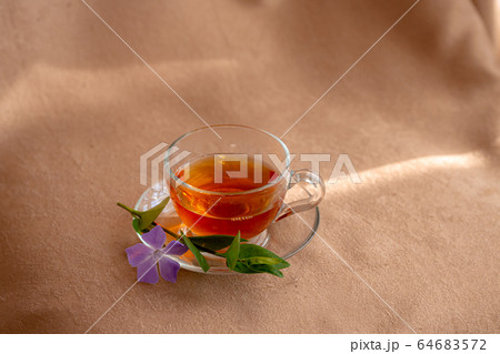 glass cup of tea with a plate by the window glass cup of tea with a plate by the window 64683572