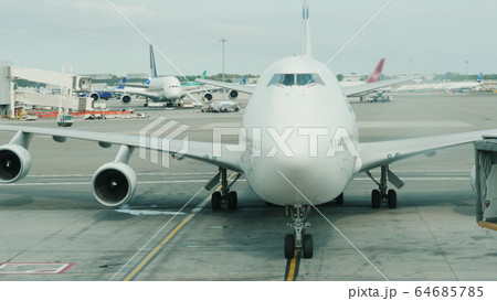 The arrival of a giant two-story airliner to the terminal. Slowly approaching the hub The arrival of a giant two-story airliner to the terminal. Slowly approaching the hub 64685785