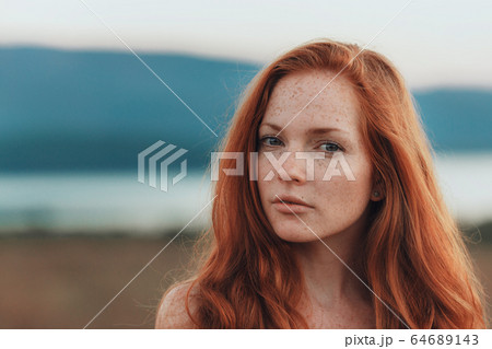 Incredible young woman with long curly hair and 64689143