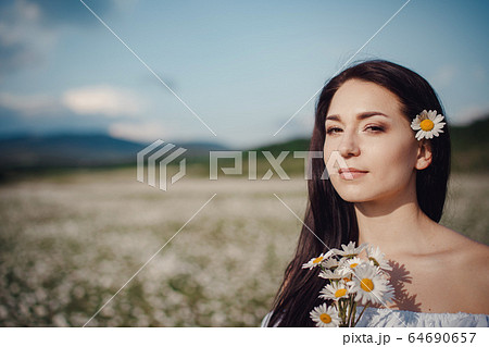 Beautiful brunette woman is enjoying spring in a Beautiful brunette woman is enjoying spring in a 64690657