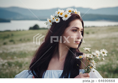 Beautiful brunette woman is enjoying spring in a Beautiful brunette woman is enjoying spring in a 64690668