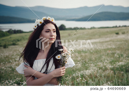 Beautiful brunette woman is enjoying spring in a Beautiful brunette woman is enjoying spring in a 64690669