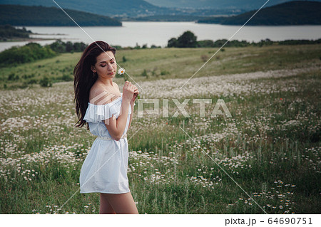 Beautiful brunette woman is enjoying spring in a 64690751