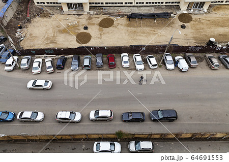 House under construction, street and parked cars 64691553