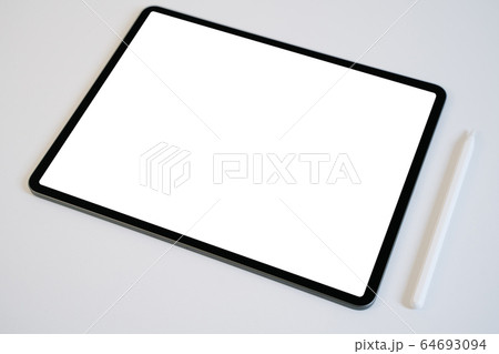 Mockup of tablet and digital pencil with blank white screen on white table. 64693094