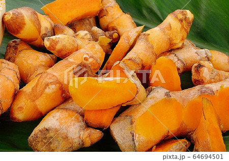 Turmeric powder and fresh turmeric on leave  background. herb high vitamin C. vitamin c for protect virus. 64694501