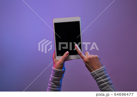 Close-up of man's hands with smartphone and blank black screen on blank purple background. Close-up of man's hands with smartphone and blank black screen on blank purple background. 64696477