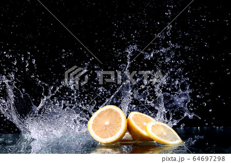 Sliced lemon in the water on black background Sliced lemon in the water on black background 64697298