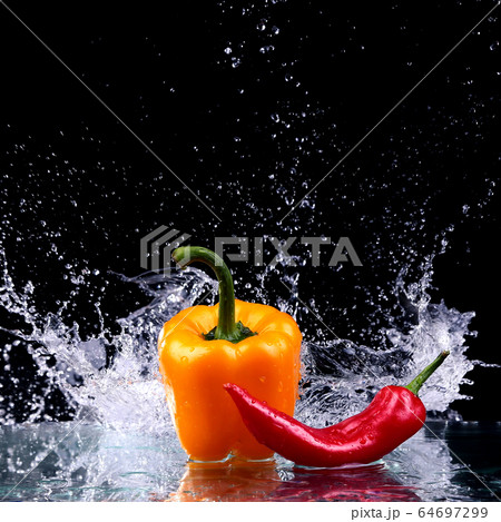 Studio shot with freeze motion of peppers in water Studio shot with freeze motion of peppers in water 64697299