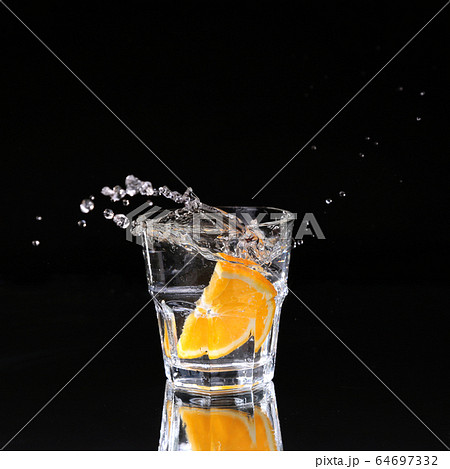 martini cocktail splashing into glass on black 64697332