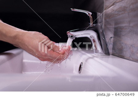 Coronavirus pandemic prevention wash hands with soap warm water rubbing fingers washing frequently 64700649