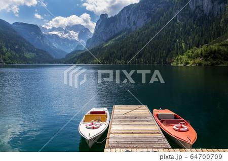 Vorderer Gosausee lake near Gosau with melting glacier in background, Austria, sunny summer day 64700709